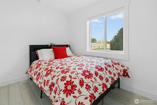 a bedroom with a bed and window