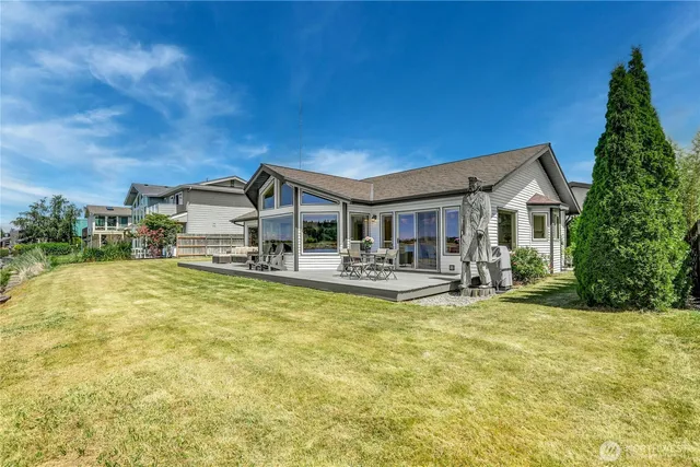 a view of a house with swimming pool and a yard