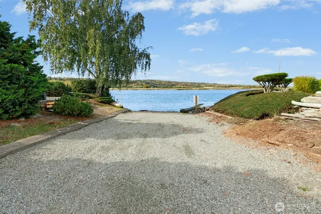 a view of backyard with swimming pool and outdoor seating