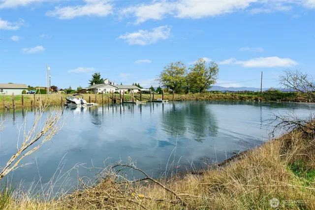a view of a lake with houses in the back