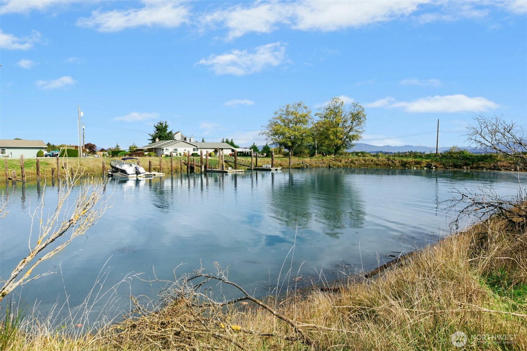 14938 Channel Lane La Conner, WA 98257 - Photo 35 of 40 a view of a lake with houses in the back