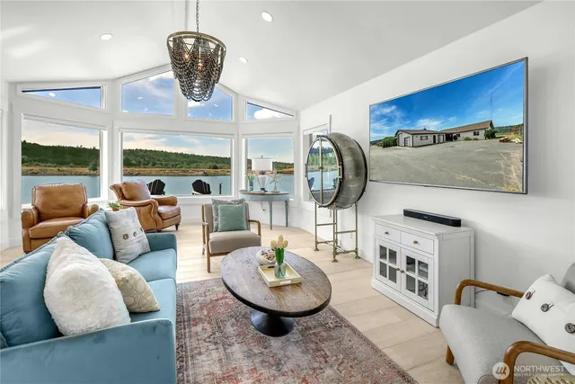 a living room with furniture a rug and a large window