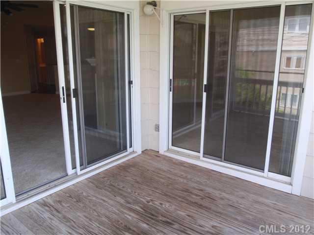 1133 Torrence Circle, Unit 1133 Davidson, NC 28036 - Photo 11 of 11 an empty room and wooden door