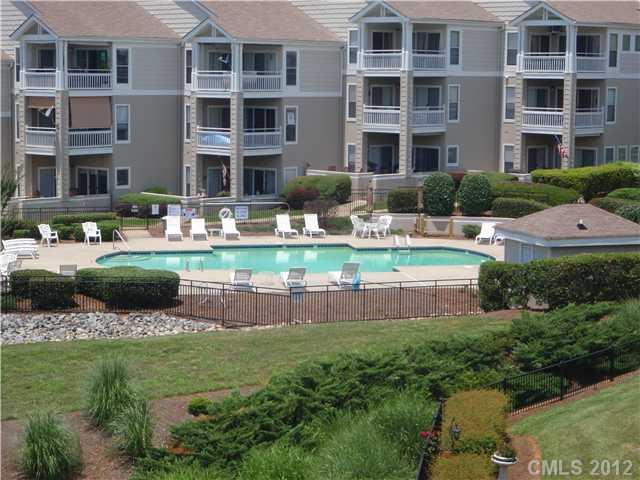 1133 Torrence Circle, Unit 1133 Davidson, NC 28036 - Photo 10 of 11 a front view of a building with a garden and plants