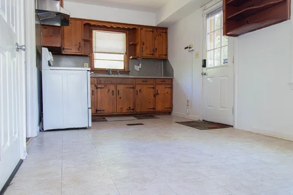 a view of a kitchen with a sink and cabinets