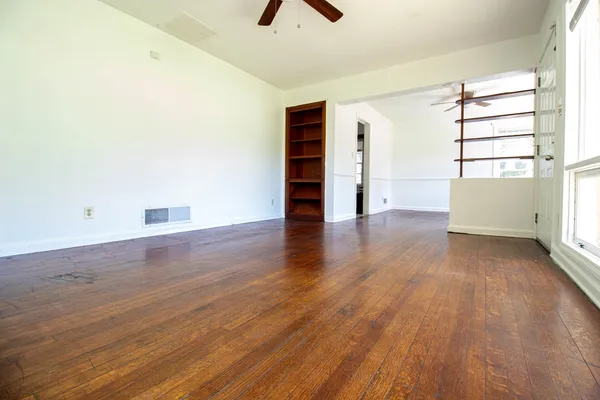 wooden floor in an empty room with a window