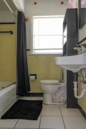 a bathroom with a toilet a sink and a window