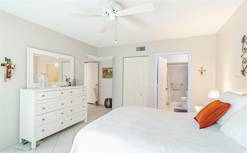 2296 Monaco Lane, Unit 8 Clearwater, FL 33763 - Photo 13 of 28 a bedroom with a bed and a dresser in it