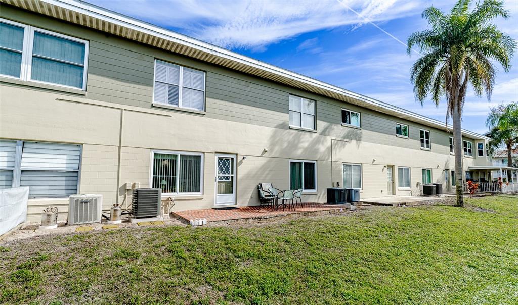 2296 Monaco Lane, Unit 8 Clearwater, FL 33763 - Photo 18 of 28 a view of a building with a yard