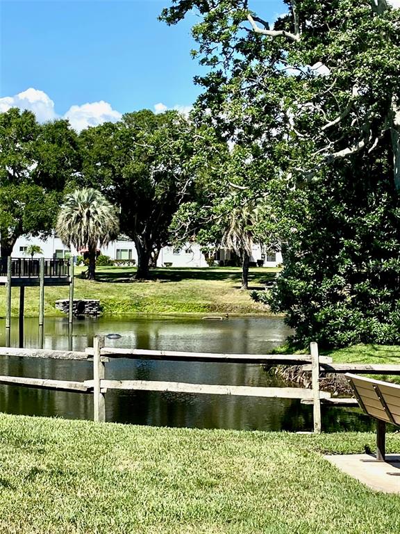 2296 Monaco Lane, Unit 8 Clearwater, FL 33763 - Photo 23 of 28 a view of swimming pool with a yard