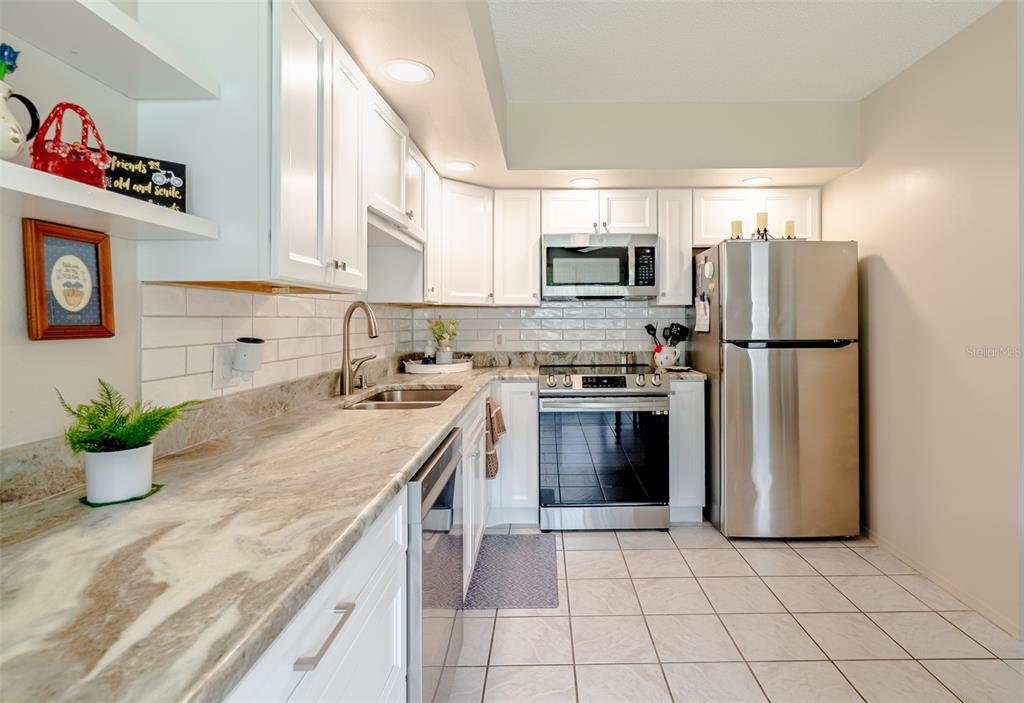 2296 Monaco Lane, Unit 8 Clearwater, FL 33763 - Photo 7 of 28 a kitchen with a refrigerator sink and stove