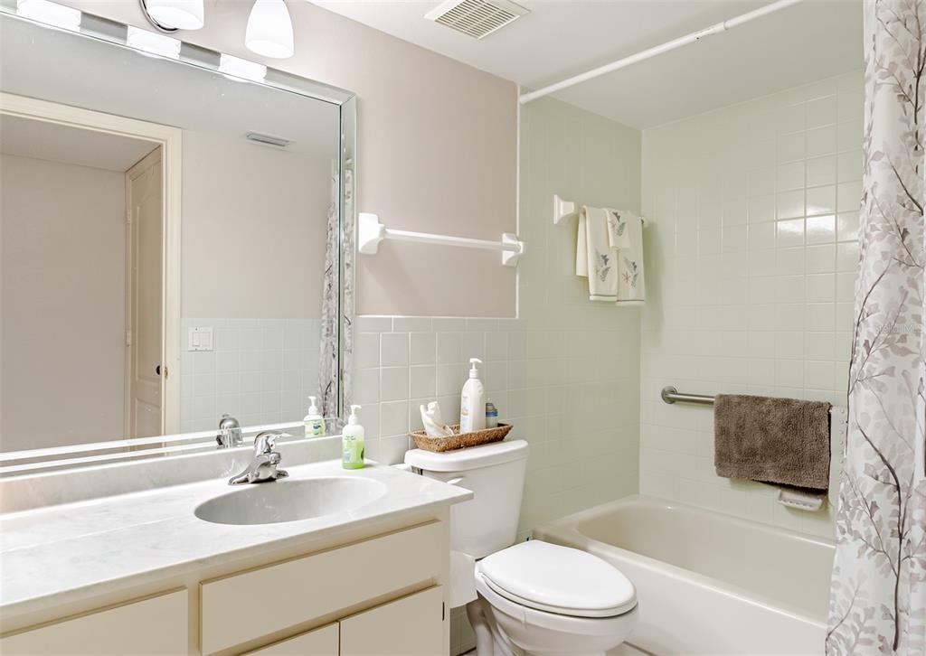 2296 Monaco Lane, Unit 8 Clearwater, FL 33763 - Photo 8 of 28 a bathroom with a sink toilet and shower