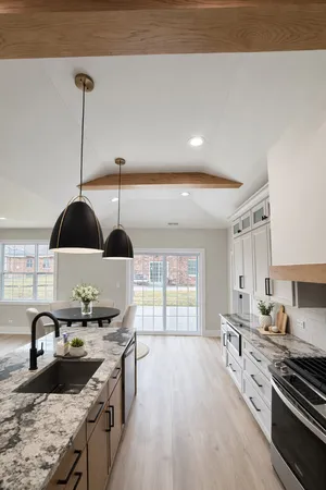 a kitchen with stainless steel appliances granite countertop a sink stove and cabinets