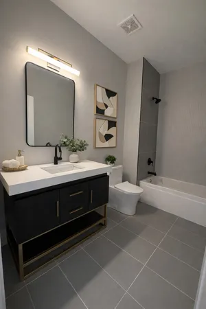 a bathroom with a sink vanity mirror and toilet