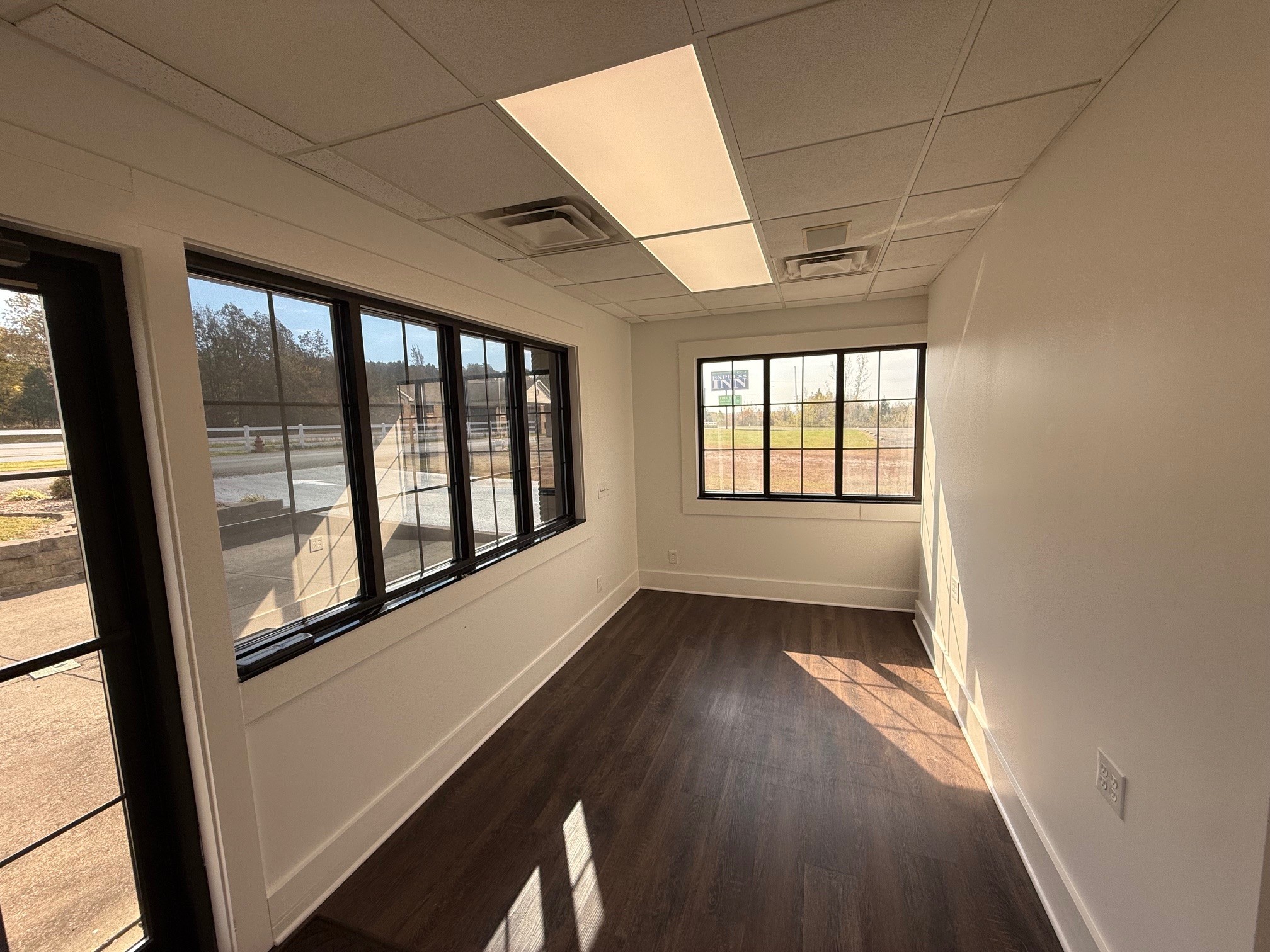 2007 West Everly Brothers Boulevard Powderly, KY 42367 - Photo 13 of 22 wooden floor in an empty room with a window