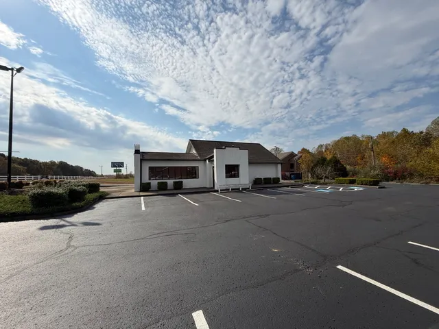a couple of cars parked in front of a building