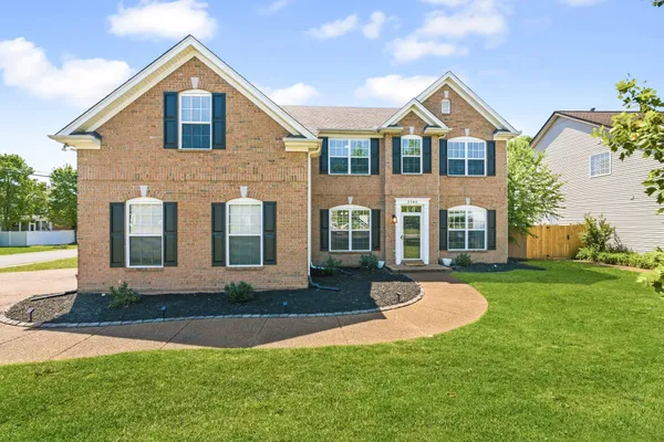 a front view of a house with a yard