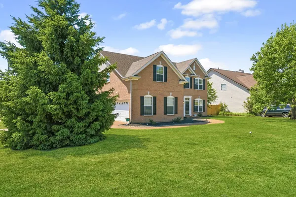 a front view of a house with a yard