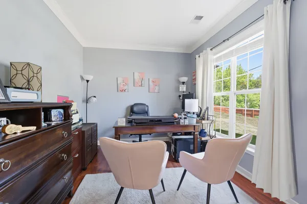 a bedroom with furniture and a flat screen tv