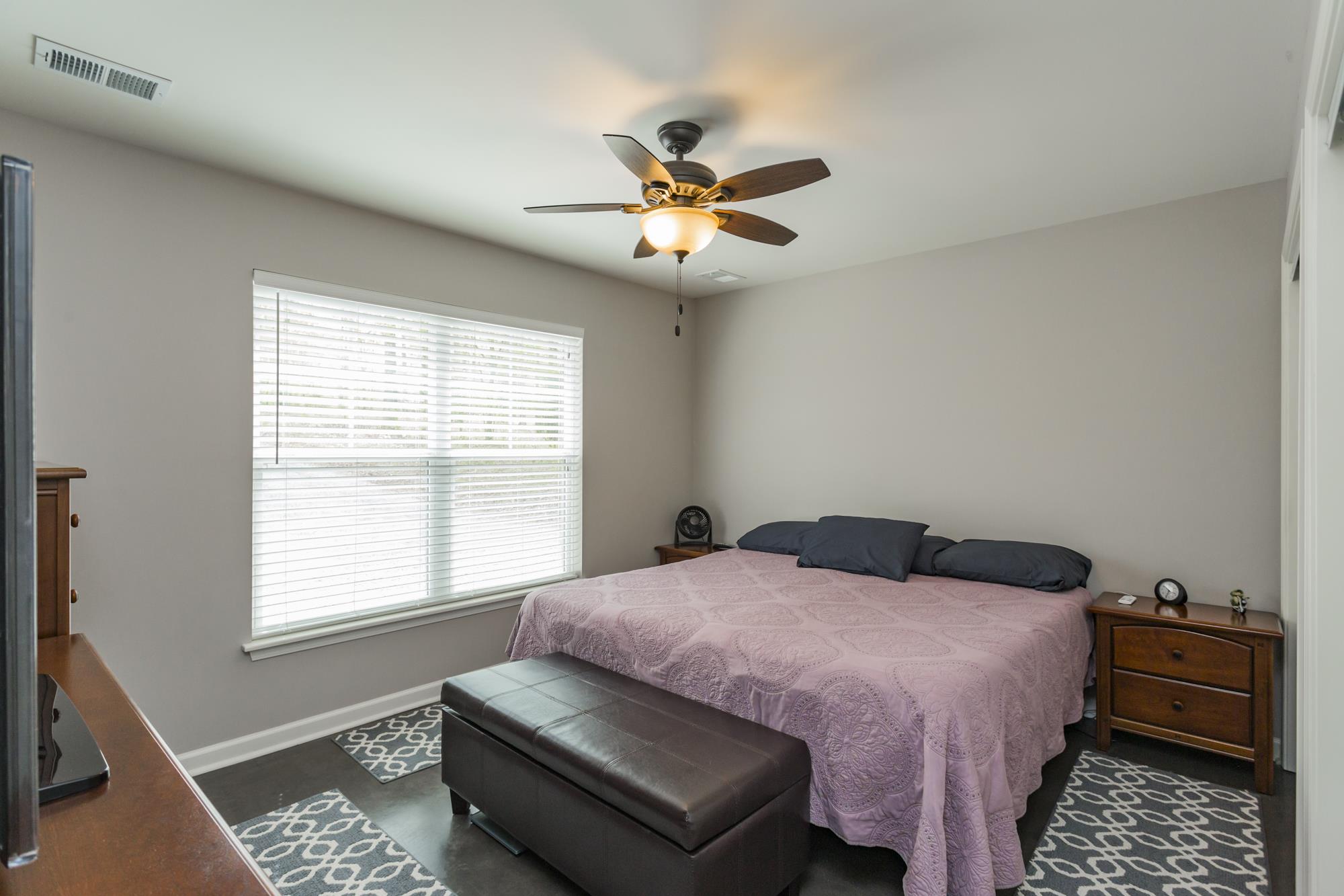 1354 Campbell Ridge Road Kingston Springs, TN 37082 - Photo 21 of 26 a bedroom with a bed and a chandelier