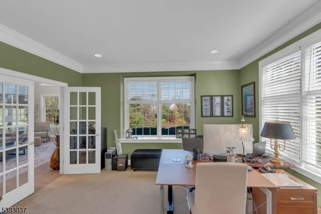 a living room with fireplace furniture and a large window
