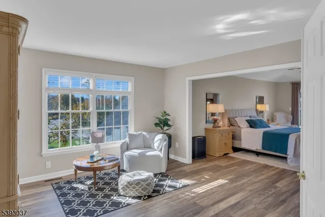 a bedroom with a large bed and a chandelier