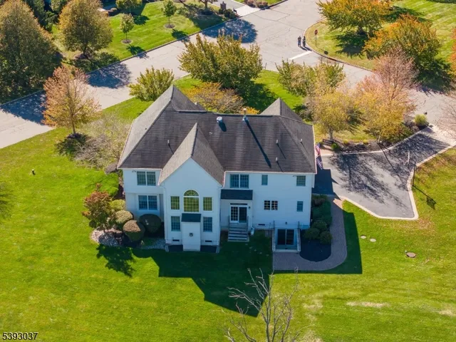 a aerial view of a house with swimming pool and a yard