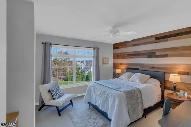 a bedroom with a bed and a potted plant