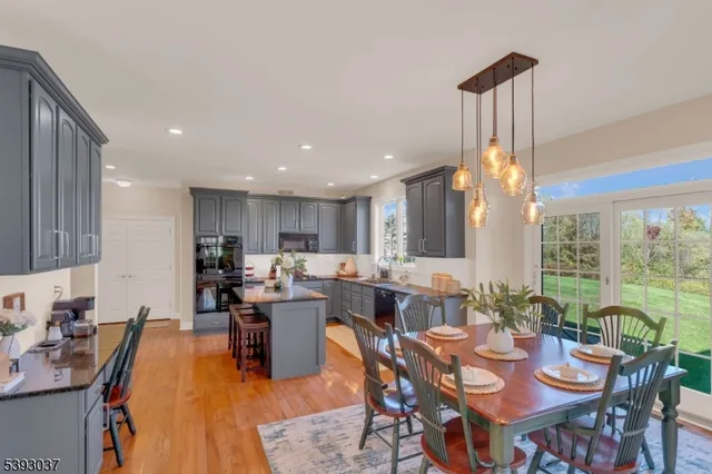 a dining room with lots of tables a large window and chairs