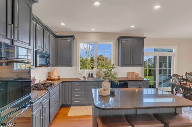 a kitchen with granite countertop a sink and a stove