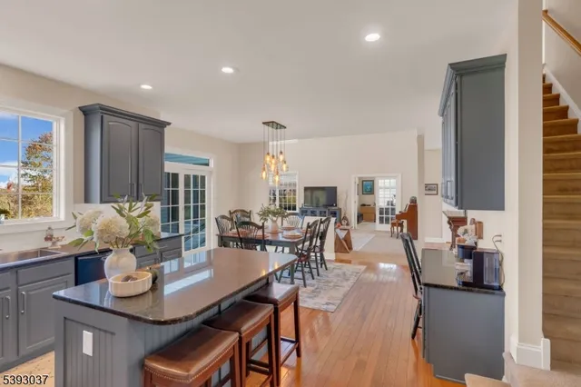 a living room with furniture kitchen view and large windows