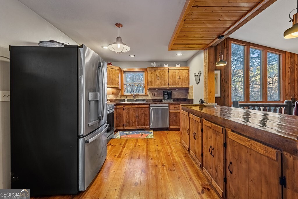 90 Hay Lane Morganton, GA 30560 - Photo 11 of 77 a kitchen with stainless steel appliances granite countertop a refrigerator a sink dishwasher a stove and white cabinets with wooden floor