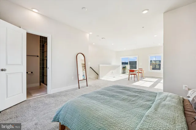 a bedroom with a bed and a large mirror