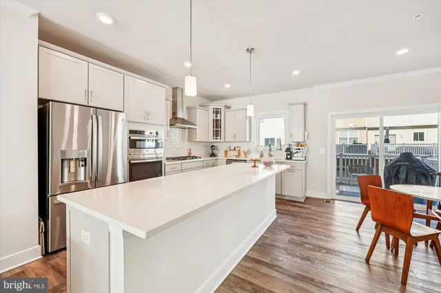 a large kitchen with stainless steel appliances kitchen island a large island in the center