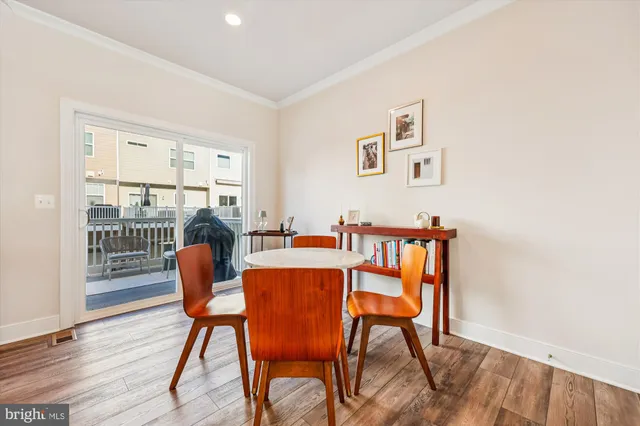 a dining room with furniture and wooden floor