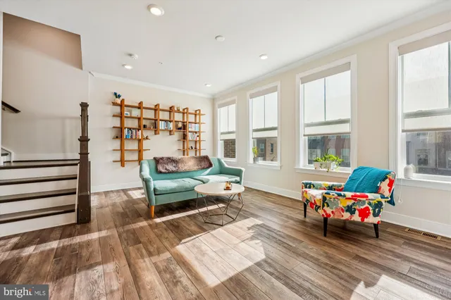 a bedroom with furniture and a large window