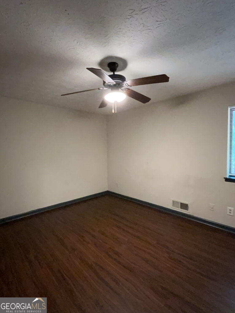 1265 Herrington Road Lawrenceville, GA 30044 - Photo 20 of 52 a view of an empty room with wooden floor