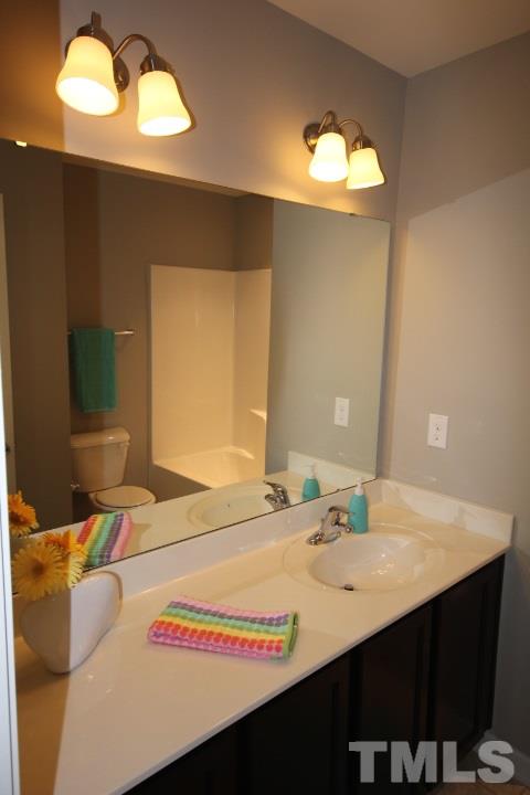1014 Grand Ridge Drive Rolesville, NC 27571 - Photo 16 of 25 a dining room with a sink table and chairs