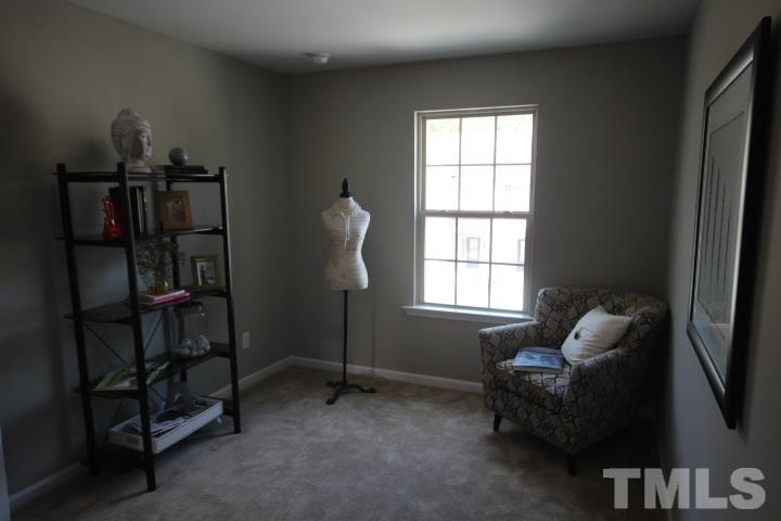 1014 Grand Ridge Drive Rolesville, NC 27571 - Photo 17 of 25 a living room with furniture and a window