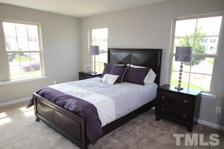 1014 Grand Ridge Drive Rolesville, NC 27571 - Photo 19 of 25 a bedroom with a bed and a window
