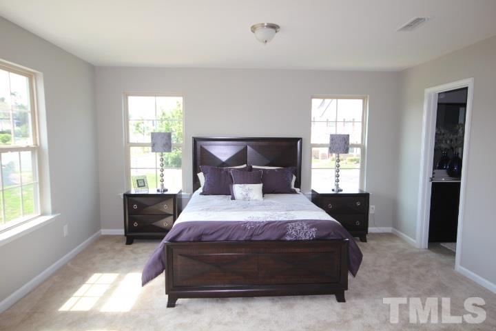 1014 Grand Ridge Drive Rolesville, NC 27571 - Photo 24 of 25 a bedroom with a bed and window