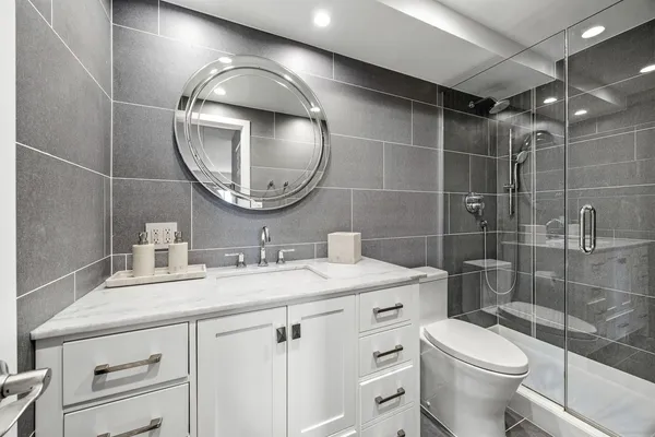 a bathroom with a toilet a sink and mirror