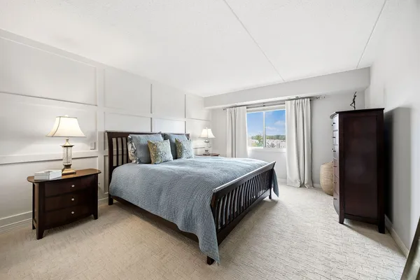 a bed room with a bed and a night stand