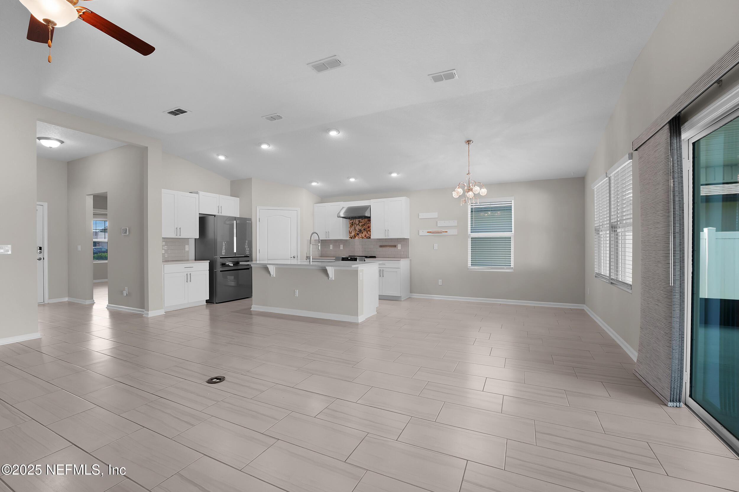 516 Lumpkin Street Jacksonville, FL 32222 - Photo 14 of 45 a view of kitchen with kitchen island white cabinets and refrigerator