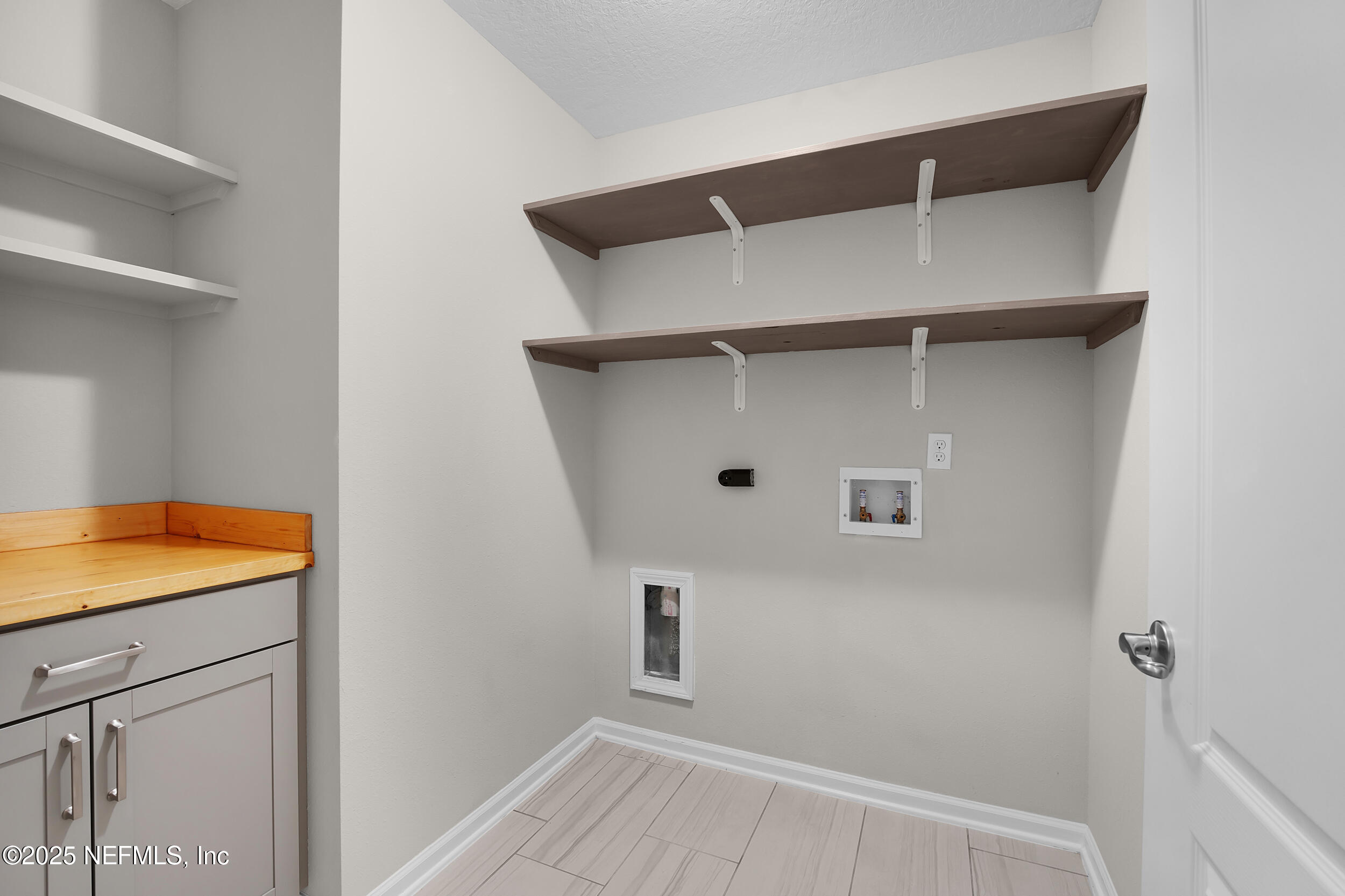 516 Lumpkin Street Jacksonville, FL 32222 - Photo 16 of 45 a view of walk in closet with empty racks