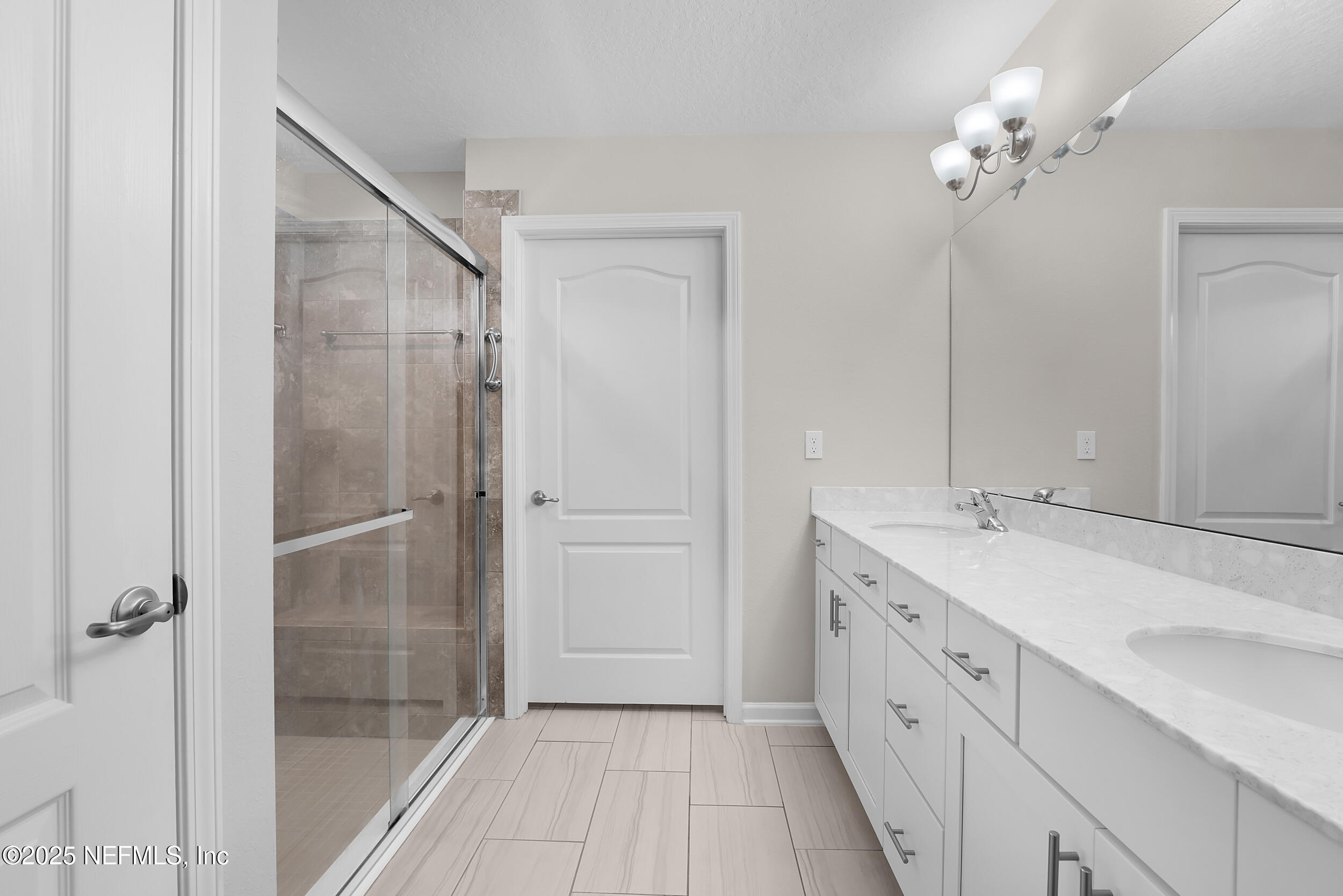 516 Lumpkin Street Jacksonville, FL 32222 - Photo 19 of 45 a spacious bathroom with a double vanity sink a mirror and a shower