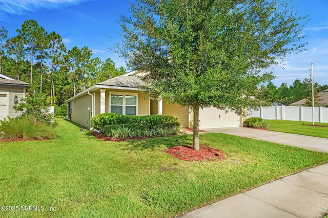 a house with green field in front of it