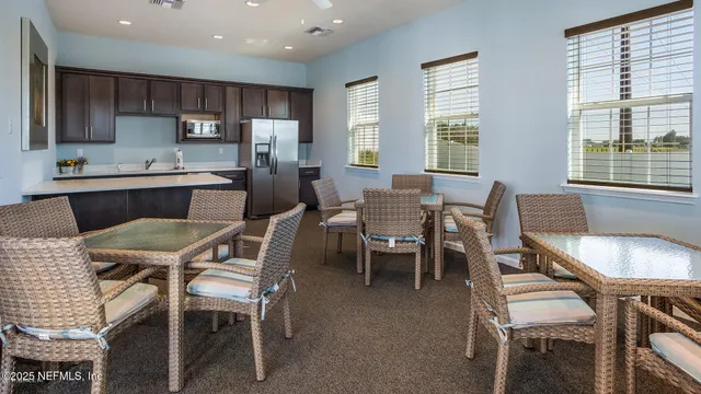 a dining room with furniture and window