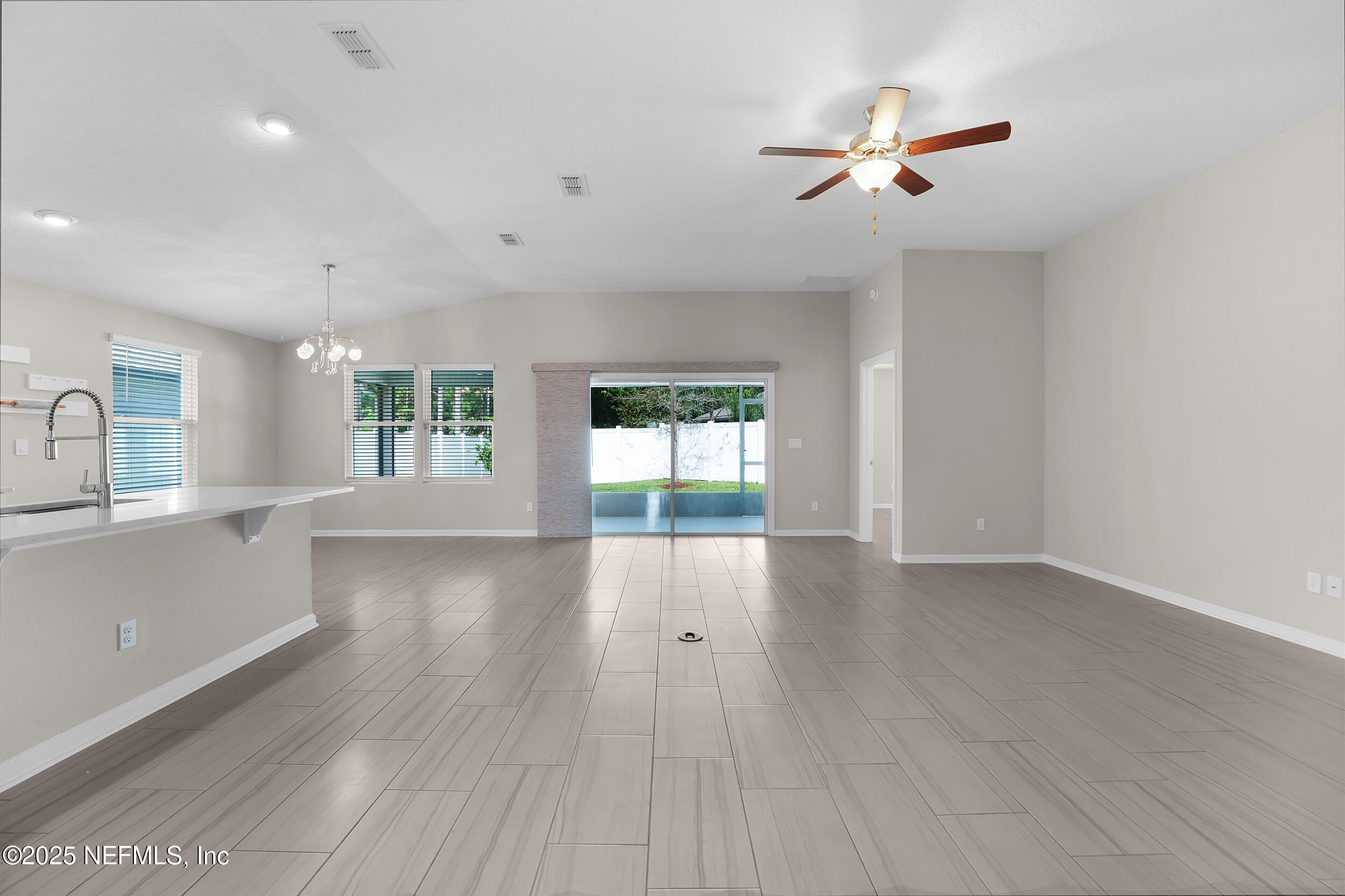516 Lumpkin Street Jacksonville, FL 32222 - Photo 7 of 45 a view of an empty room with a window and wooden floor