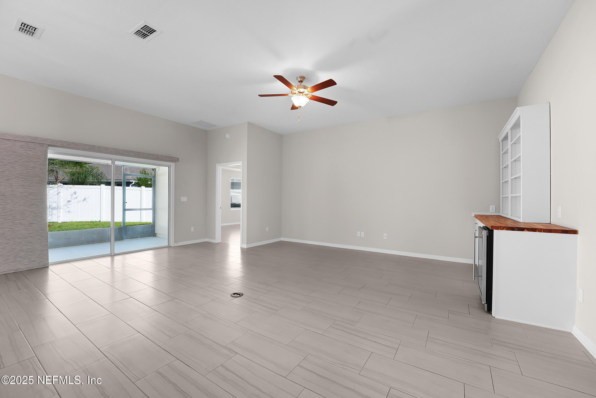 516 Lumpkin Street Jacksonville, FL 32222 - Photo 8 of 45 wooden floor in an empty room with a window
